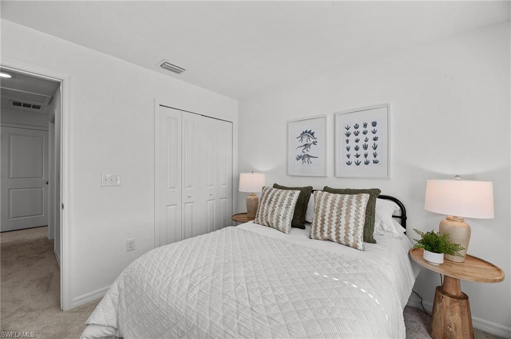 17251 Monte Isola Way North Fort Myers, FL 33917 - Photo 26 of 39 a bedroom with a bed and lamp