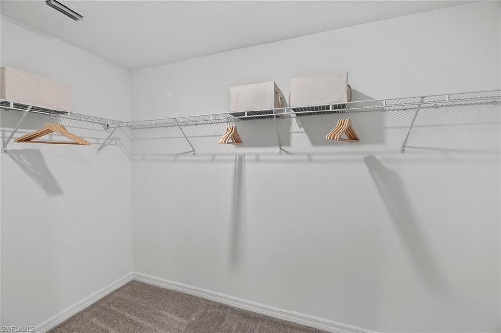 17251 Monte Isola Way North Fort Myers, FL 33917 - Photo 31 of 39 a view of walk in closet with empty racks