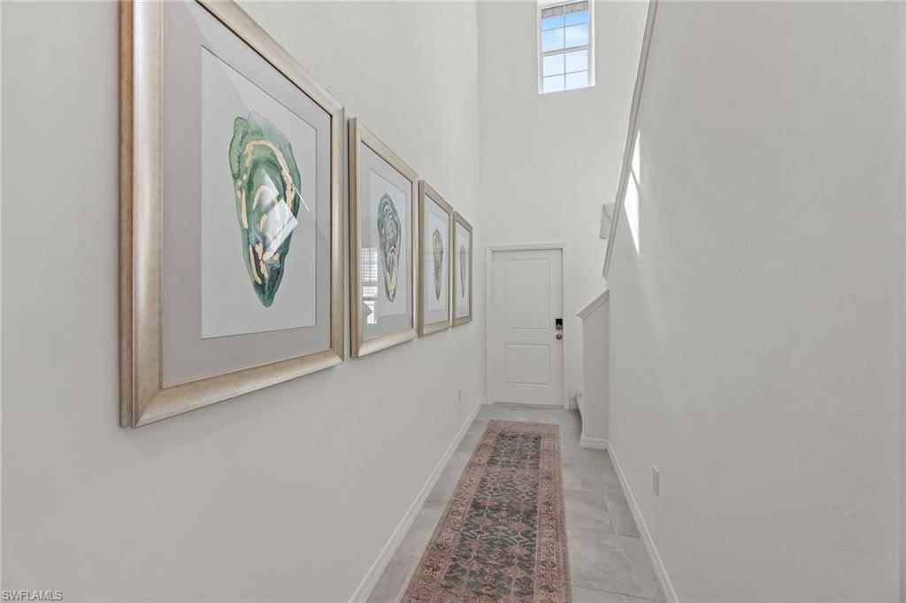 17251 Monte Isola Way North Fort Myers, FL 33917 - Photo 5 of 39 a view of a hallway with wooden floor and closet