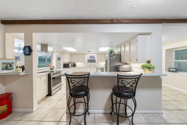 a living room with furniture a dining table and chairs