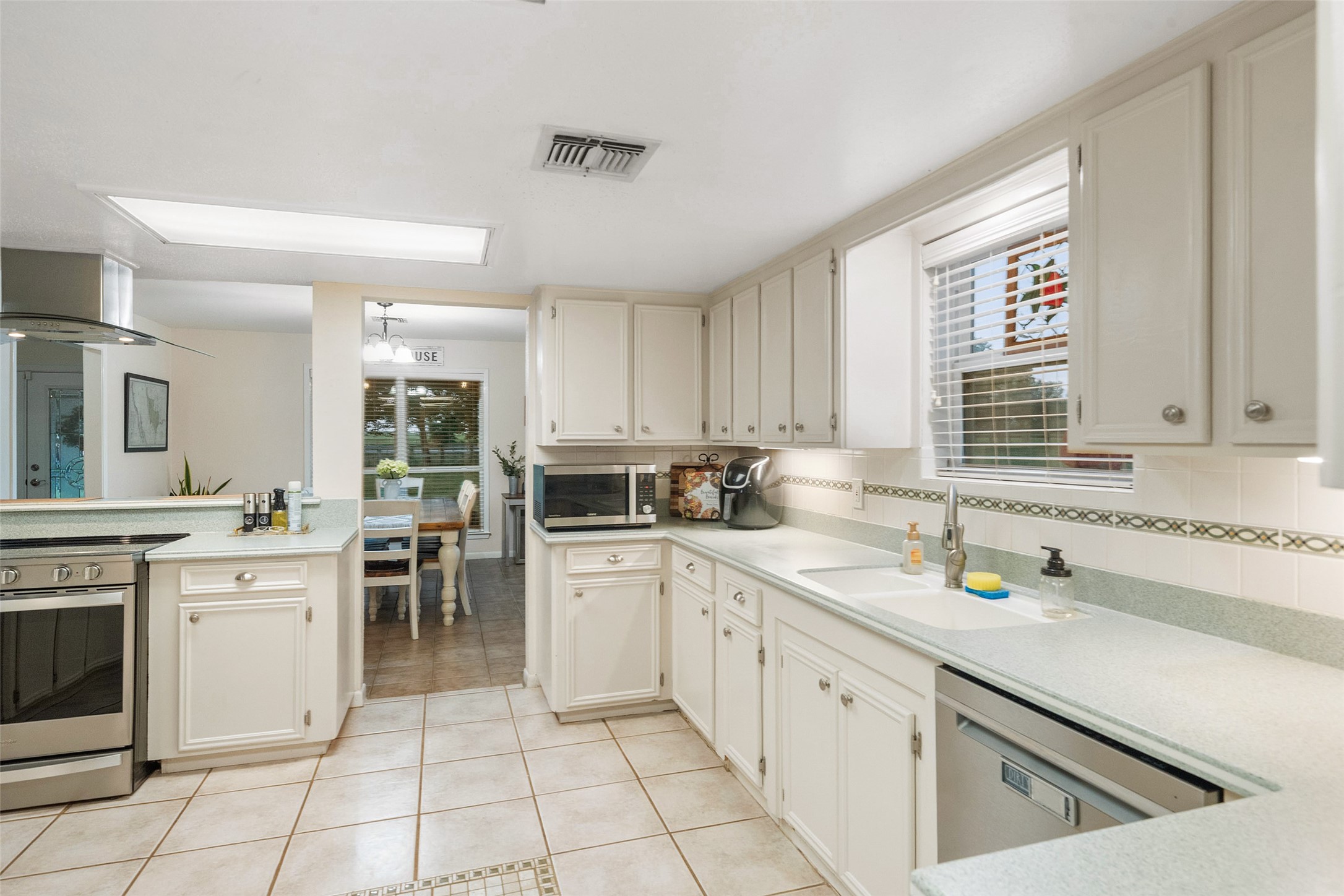 21348 Farm To Market 359 Hempstead, TX 77445 - Photo 13 of 48 a kitchen with a stove sink and cabinets