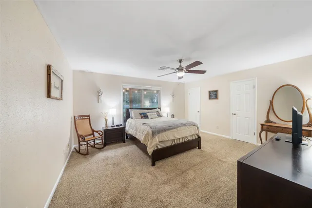 a view of a swimming pool with a yard and a fountain
