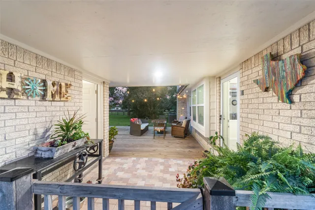 a view of a green field with trees in the background
