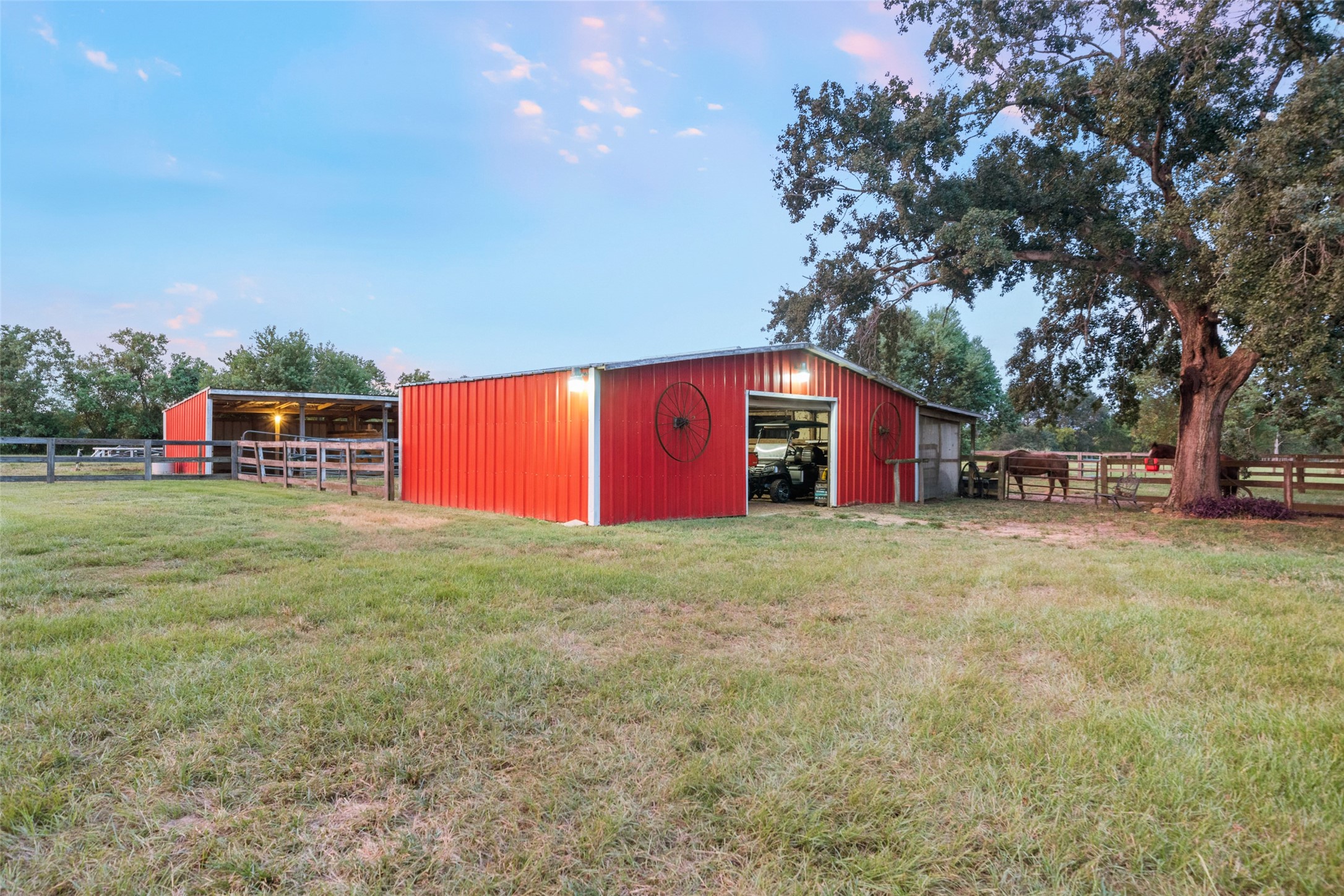 21348 Farm To Market 359 Hempstead, TX 77445 - Photo 39 of 48 Expansive red barn with covered storage wing and sturdy fencing provides excellent functionality for livestock or equipment.