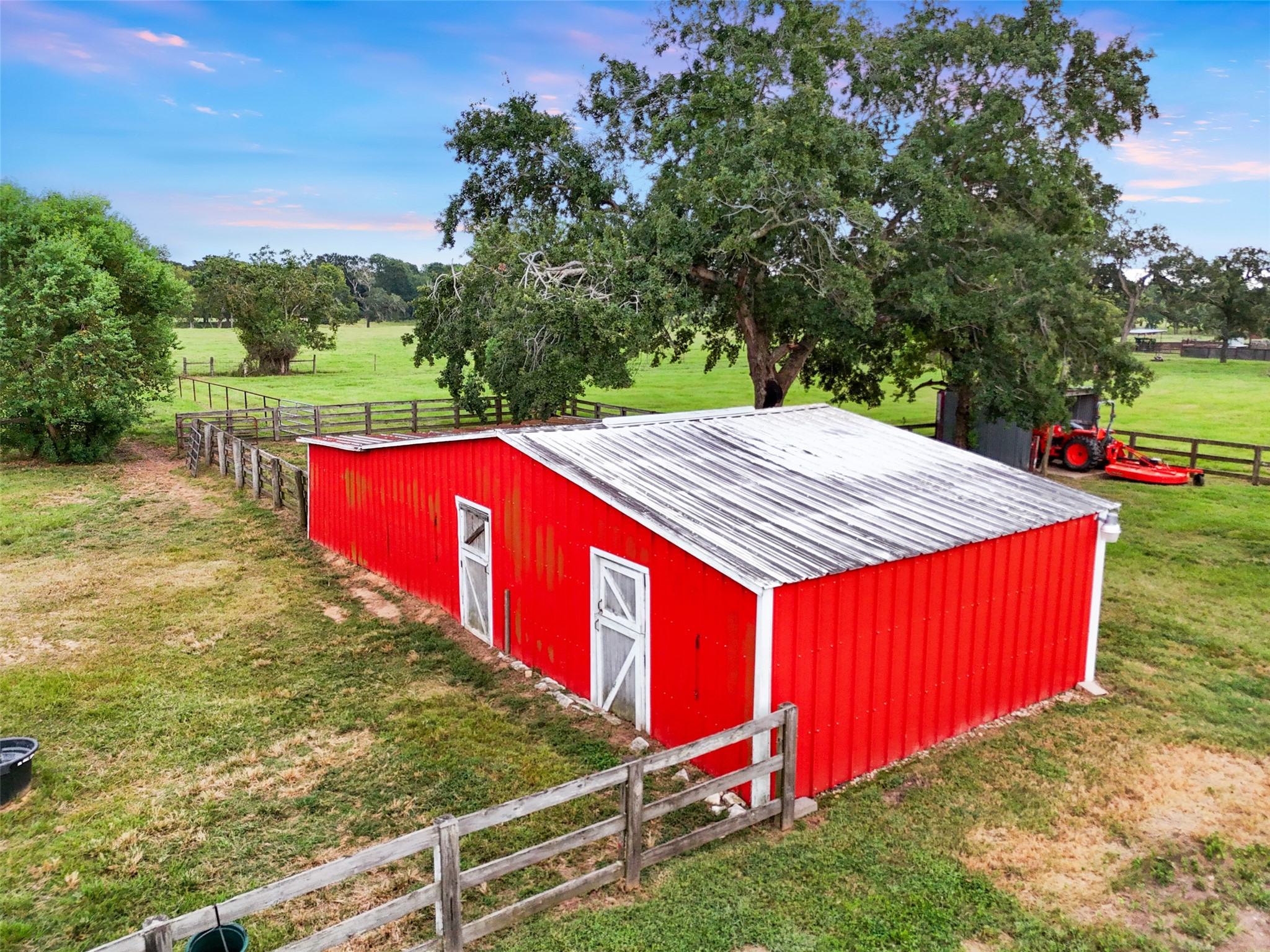 21348 Farm To Market 359 Hempstead, TX 77445 - Photo 42 of 48 Aerial perspective of the barns and paddocks, designed for functionality with excellent fencing and easy access for farm operations.