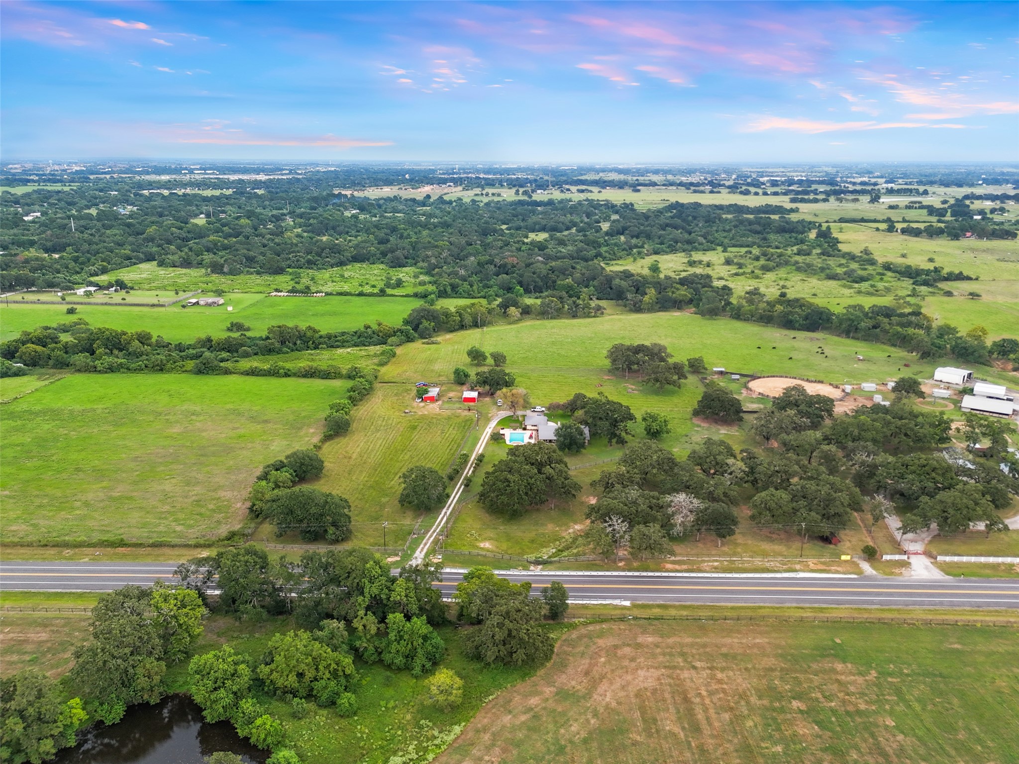 21348 Farm To Market 359 Hempstead, TX 77445 - Photo 45 of 48 Wide aerial view showing convenient frontage along FM 359 with gated entry leading to the driveway and improvements.