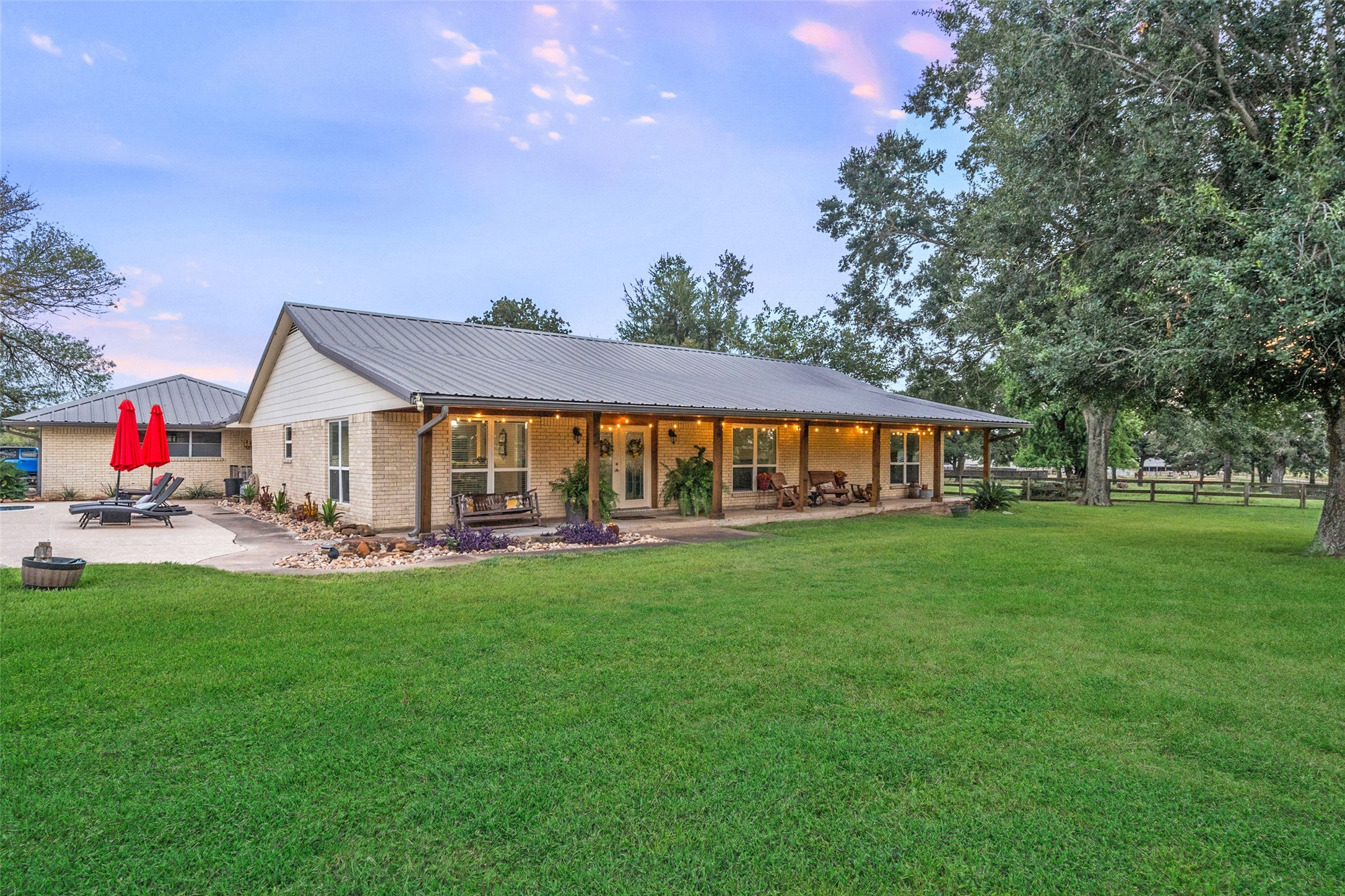 21348 Farm To Market 359 Hempstead, TX 77445 - Photo 7 of 48 Generous green space frames the home’s welcoming façade, complemented by French drains around the house for long-term maintenance.