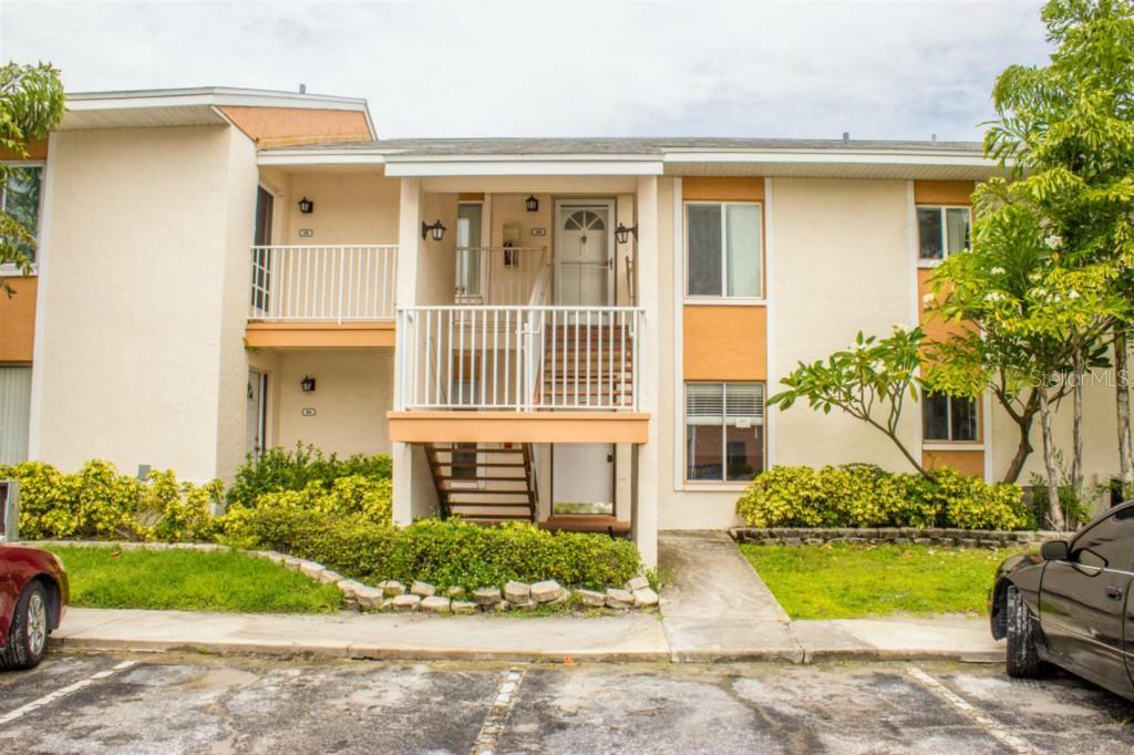 9940 7th Way North, Unit 102 St. Petersburg, FL 33702 - Photo 1 of 1 a front view of a house with a yard