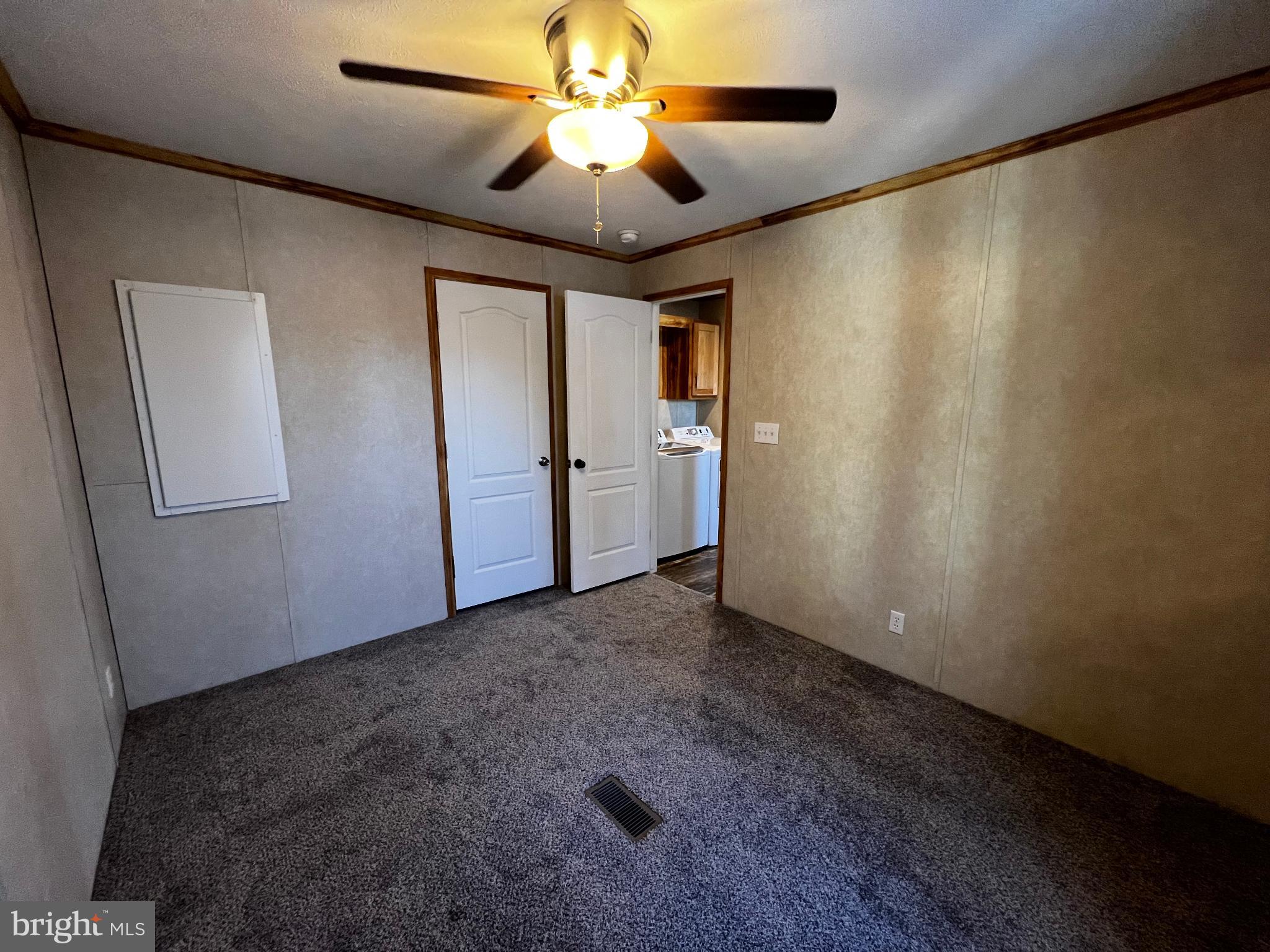 222 Kennedy Avenue Williamstown, NJ 08094 - Photo 6 of 10 an empty room with closet and a chandelier fan