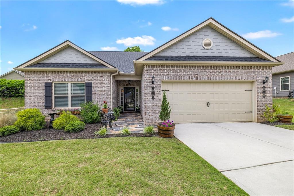 a front view of a house with a yard and garage