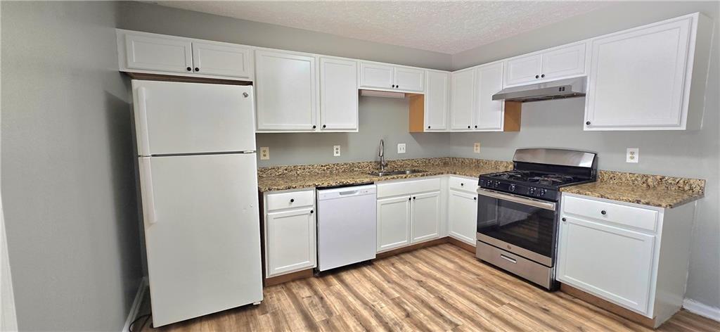 1120 Rappahannock Drive Alpharetta, GA 30009 - Photo 13 of 35 a kitchen with cabinets appliances and wooden floor