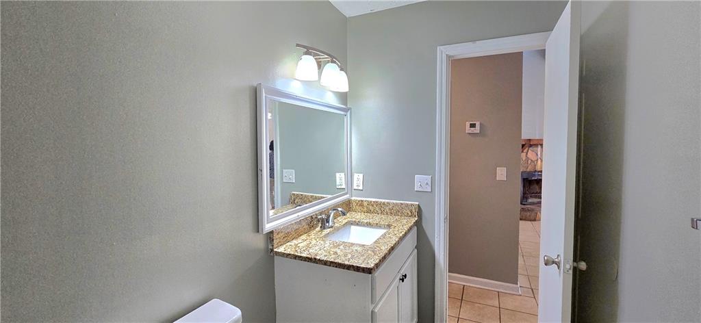 1120 Rappahannock Drive Alpharetta, GA 30009 - Photo 20 of 35 a bathroom with a granite countertop sink and a mirror