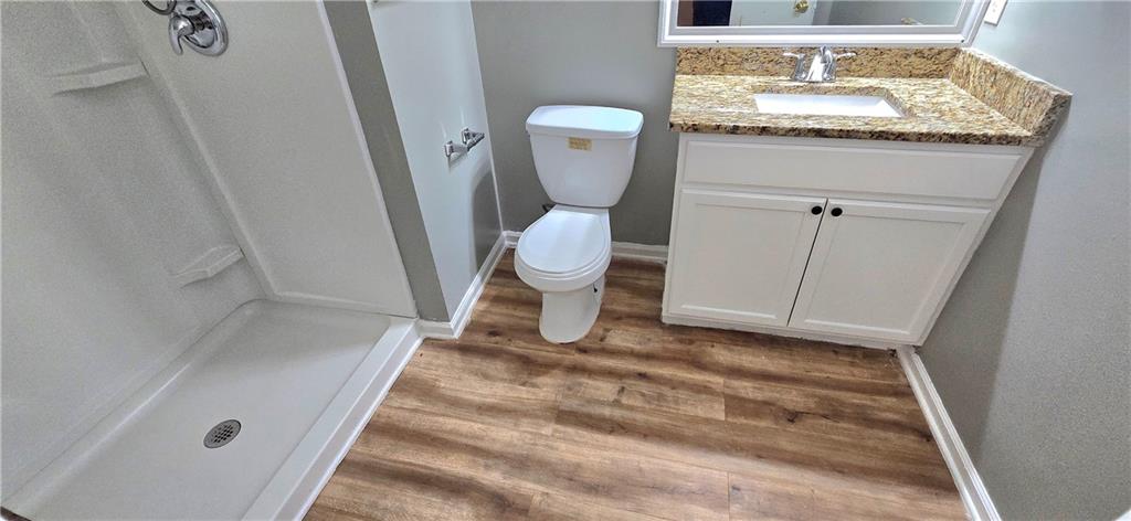 1120 Rappahannock Drive Alpharetta, GA 30009 - Photo 28 of 35 a bathroom with a granite countertop toilet and a sink
