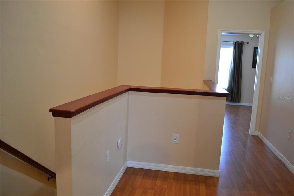 11235 Kapok Grand Circle Madeira Beach, FL 33708 - Photo 23 of 34 a view of walk in closet with wooden floor
