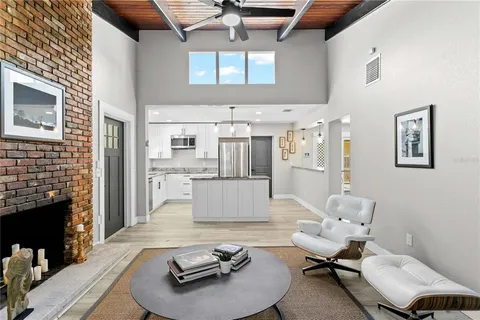 a living room with furniture kitchen view and a fireplace