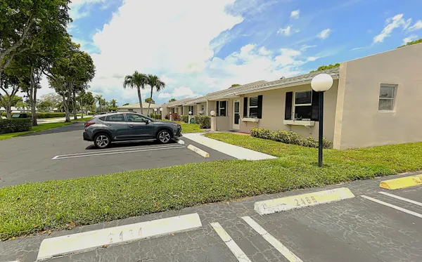 a car parked in front of a house and a yard