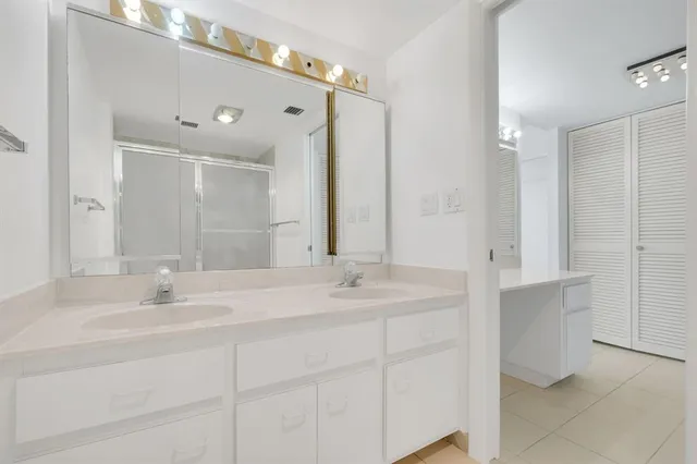 a bathroom with a double vanity sink mirror and double