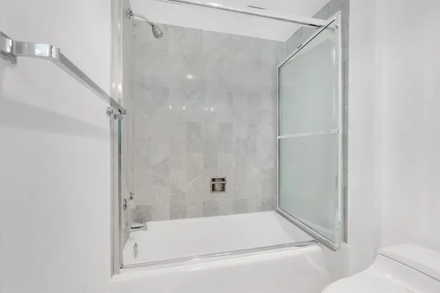 a bathroom with a bathtub and a shower