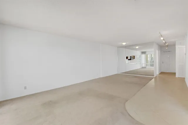 a view of kitchen with refrigerator and wooden floor