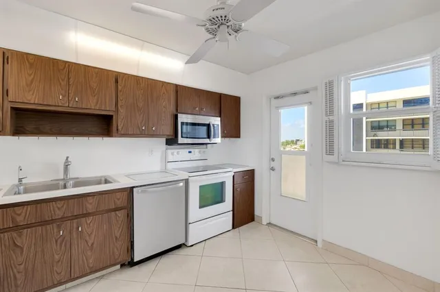 a kitchen with a sink and stainless steel appliances