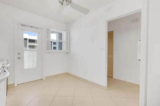 a view of a kitchen with a sink stove cabinet and a refrigerator