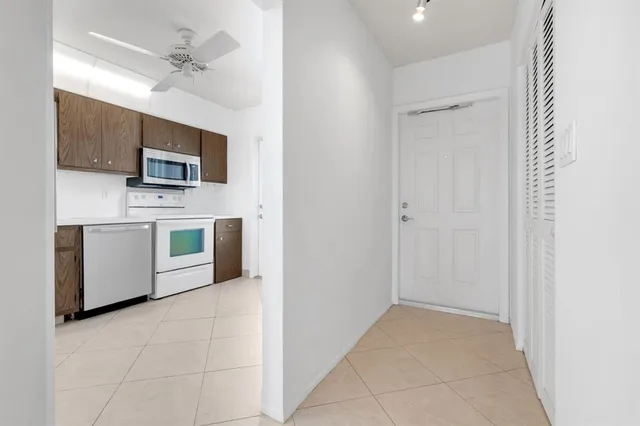 a living room with furniture and a ceiling fan