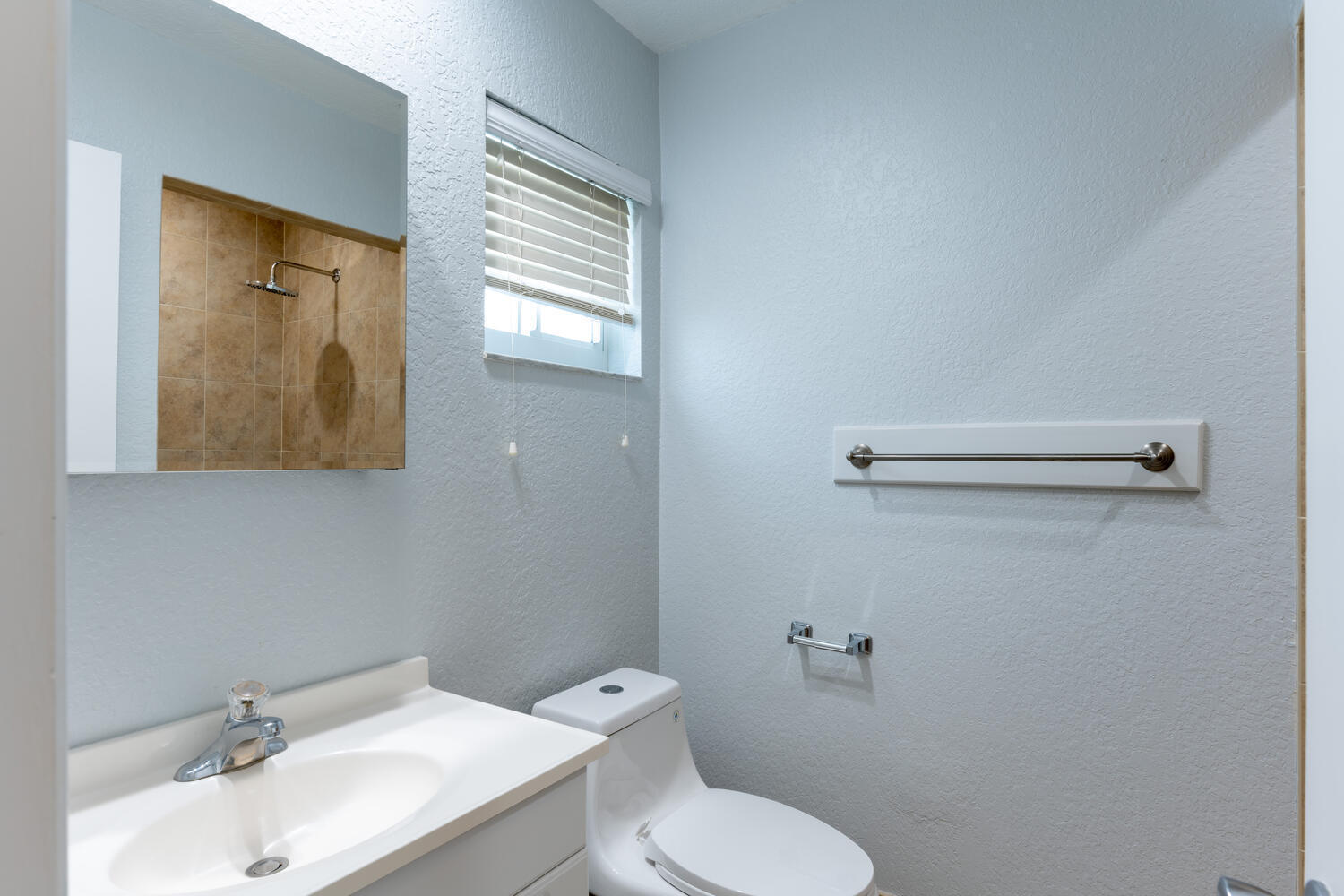4695 Brandywine Drive Boca Raton, FL 33487 - Photo 20 of 28 a bathroom with a toilet sink and mirror