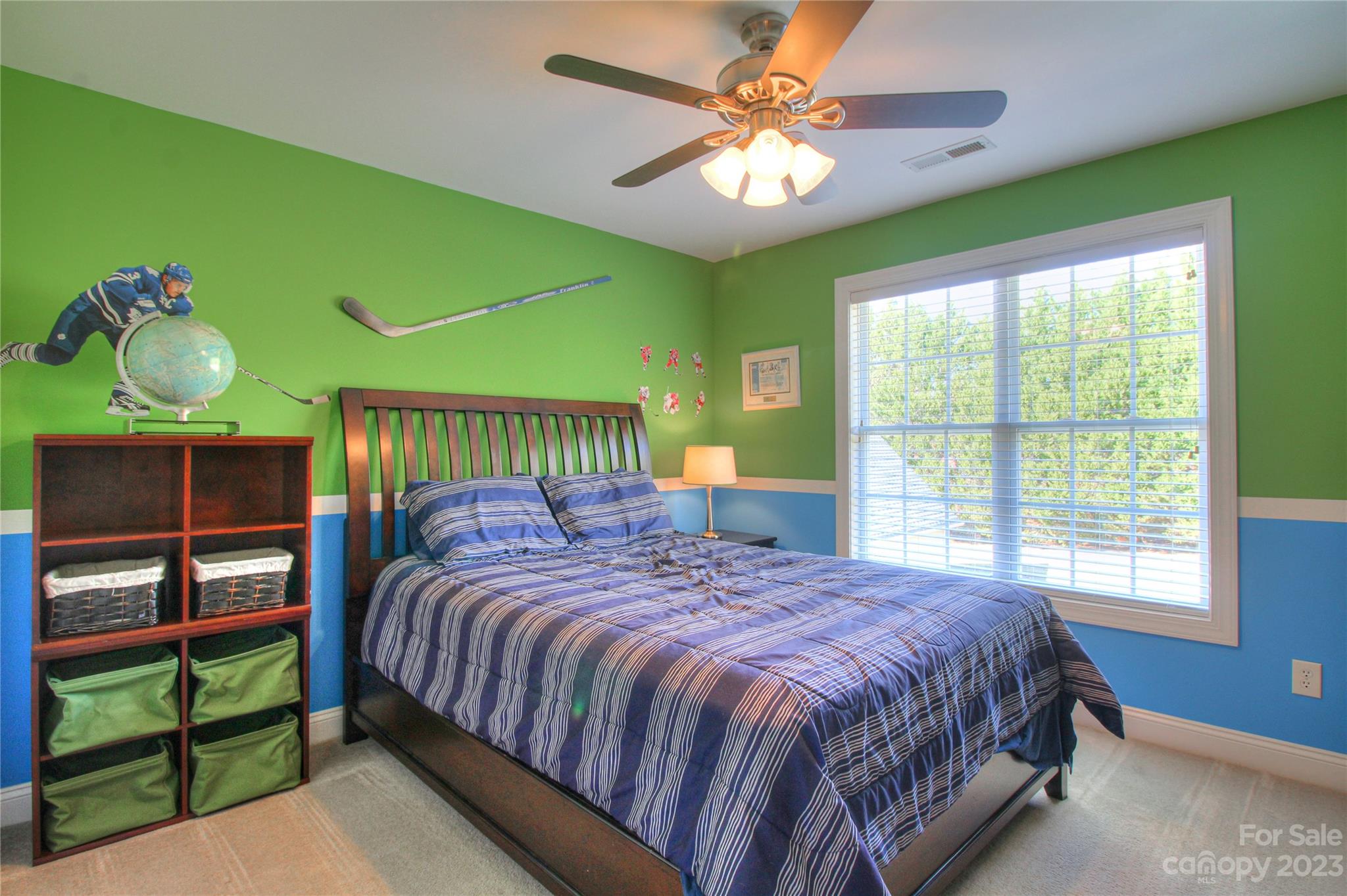 1016 Wesley Downs Road Wesley Chapel, NC 28110 - Photo 21 of 40 a bedroom with a bed and a chandelier