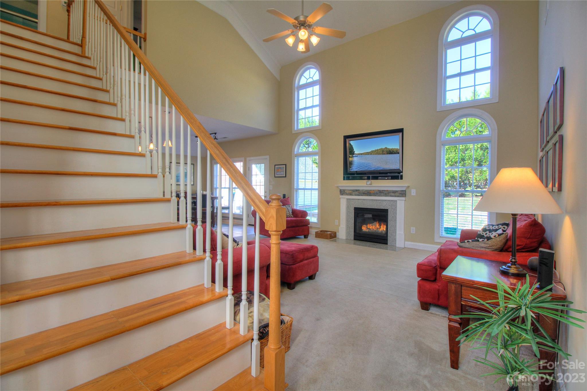 1016 Wesley Downs Road Wesley Chapel, NC 28110 - Photo 4 of 40 a living room with furniture a fireplace and a flat screen tv