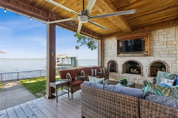 a outdoor space with patio the couches and a fireplace