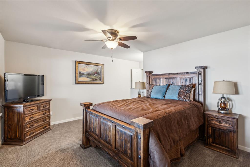 142 Peninsula Point Terrace Mabank, TX 75156 - Photo 14 of 29 a bedroom with a bed and a flat screen tv