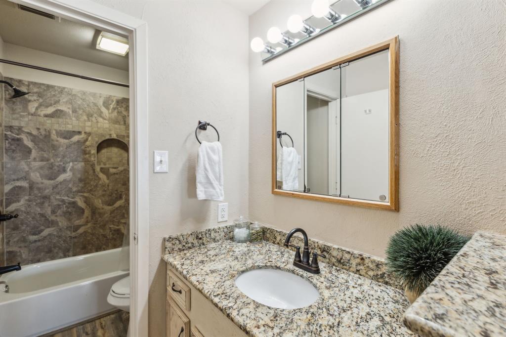 142 Peninsula Point Terrace Mabank, TX 75156 - Photo 15 of 29 a bathroom with a granite countertop sink a toilet and shower