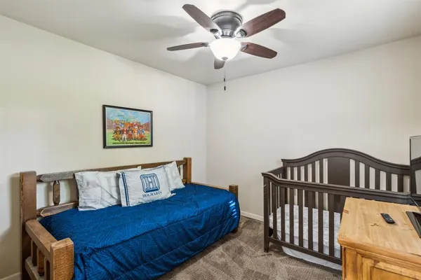 a bedroom with a bed and a chandelier