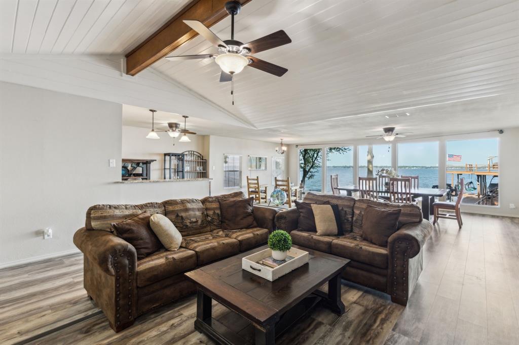 142 Peninsula Point Terrace Mabank, TX 75156 - Photo 6 of 29 a living room with furniture kitchen view and a chandelier