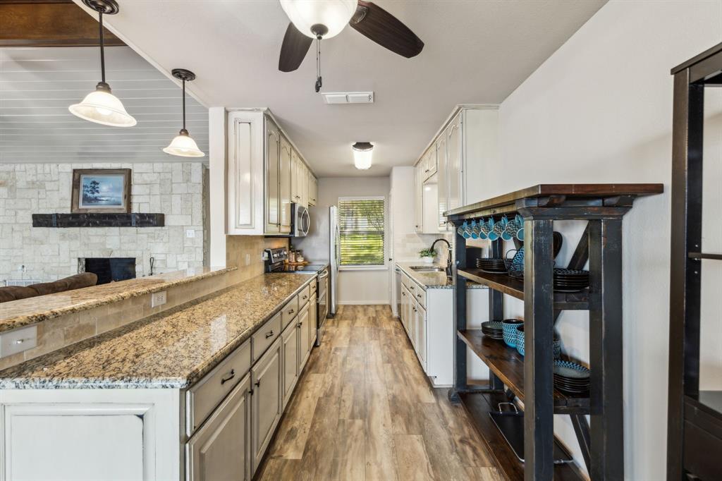 142 Peninsula Point Terrace Mabank, TX 75156 - Photo 7 of 29 a large kitchen with stainless steel appliances granite countertop a stove and cabinets