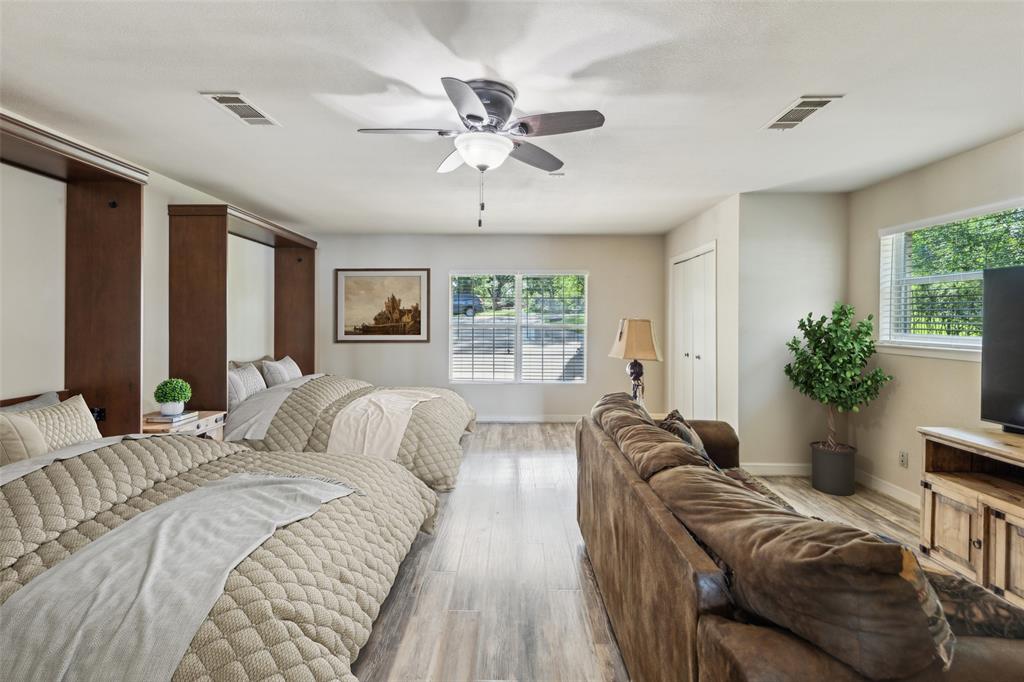 142 Peninsula Point Terrace Mabank, TX 75156 - Photo 8 of 29 a spacious bedroom with a bed and a chandelier