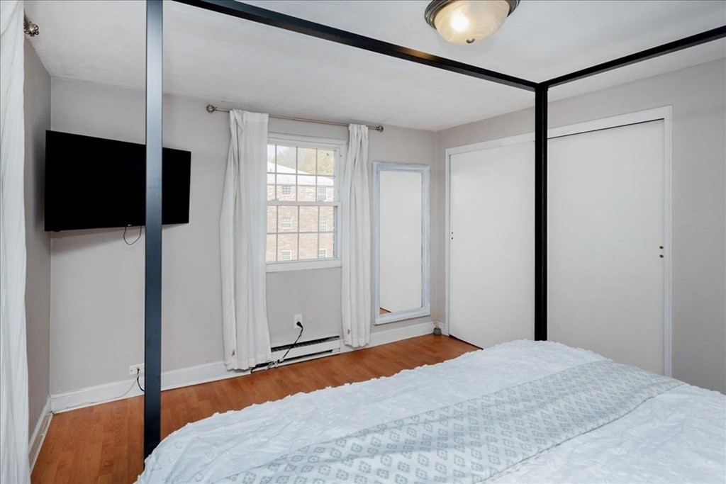 7 Walker Road, Unit 9 North Andover, MA 01845 - Photo 13 of 23 a bedroom with a bed and a flat screen tv