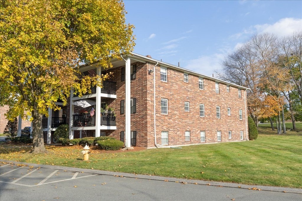 7 Walker Road, Unit 9 North Andover, MA 01845 - Photo 2 of 23 front view of a building with a garden