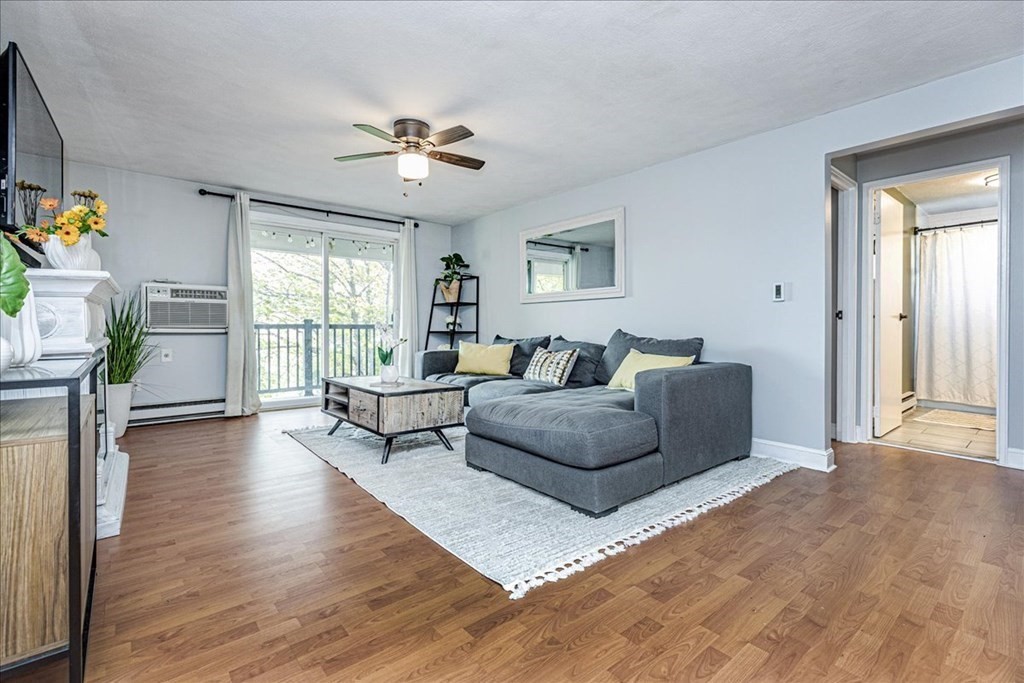 7 Walker Road, Unit 9 North Andover, MA 01845 - Photo 3 of 23 a living room with furniture and a large window