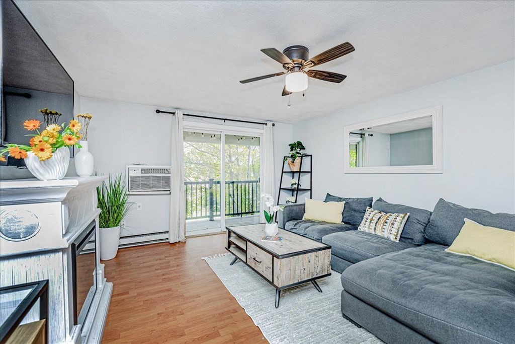 7 Walker Road, Unit 9 North Andover, MA 01845 - Photo 4 of 23 a living room with furniture and a floor to ceiling window