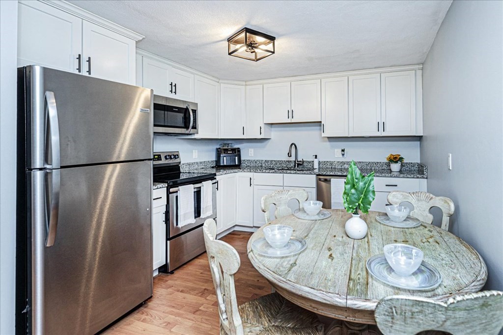7 Walker Road, Unit 9 North Andover, MA 01845 - Photo 10 of 23 a kitchen with stainless steel appliances granite countertop a sink a refrigerator and microwave