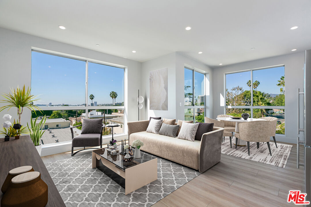 12431 Rochester Avenue, Unit 206 Los Angeles, CA 90025 - Photo 1 of 23 a living room with furniture and a large window