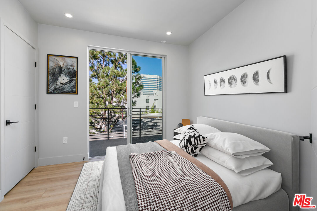 12431 Rochester Avenue, Unit 206 Los Angeles, CA 90025 - Photo 7 of 23 a bedroom with a bed and a window