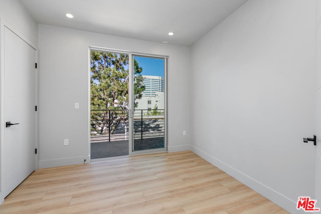 12431 Rochester Avenue, Unit 206 Los Angeles, CA 90025 - Photo 8 of 23 wooden floor in an empty room with a window