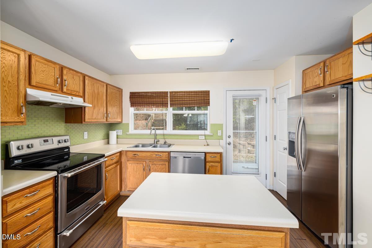 3617 Hamilton Mill Drive Raleigh, NC 27616 - Photo 7 of 20 a kitchen with a refrigerator a sink a stove and cabinets