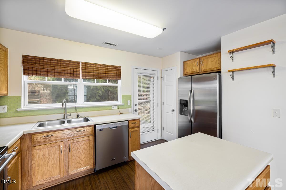 3617 Hamilton Mill Drive Raleigh, NC 27616 - Photo 9 of 20 a kitchen with a sink and refrigerator