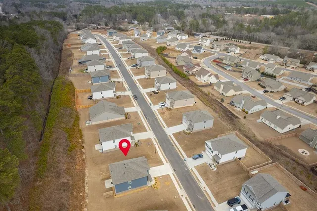 a view of a street with houses on both side of the street