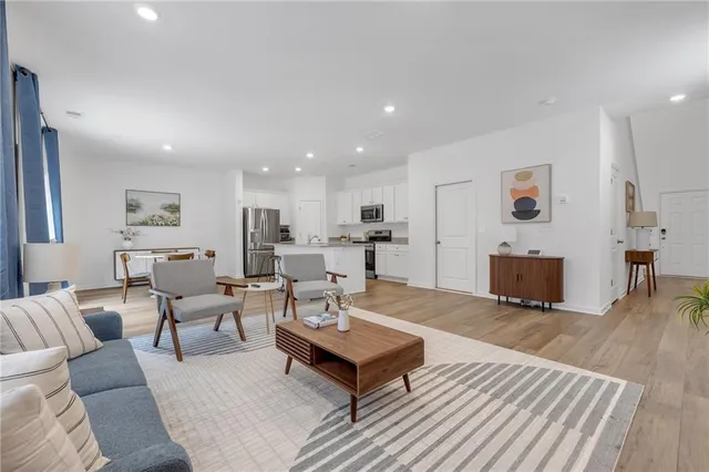 a living room with furniture and a wooden floor