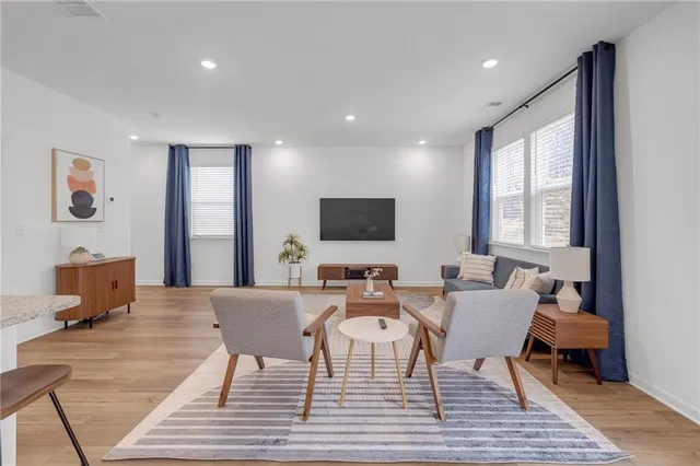 a living room with couches and a flat screen tv