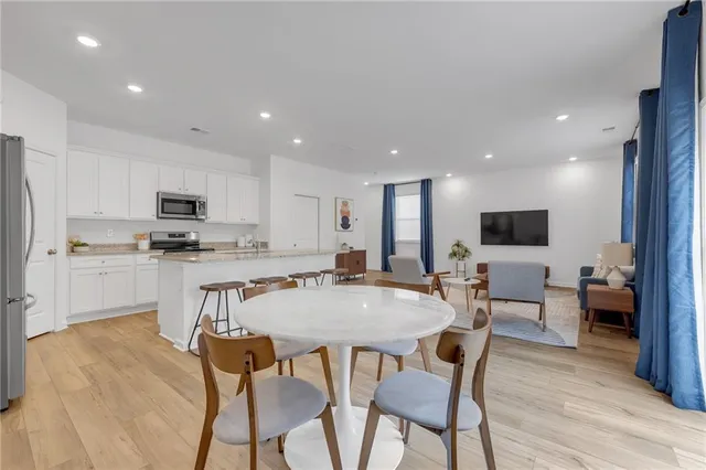 a view of kitchen with cabinets table and chairs